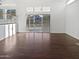 Spacious living area with wood floors, sliding glass doors, and lots of natural light at 5976 W Alameda Rd, Glendale, AZ 85310