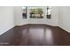 Bright living room featuring beautiful hardwood floors and large bay windows at 5976 W Alameda Rd, Glendale, AZ 85310