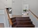 Staircase with beautiful wood stairs, white risers, and wood railing at 5976 W Alameda Rd, Glendale, AZ 85310