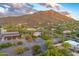 Panoramic aerial view of a desert community with homes nestled against a majestic mountain at 6002 E Cholla Rd, Cave Creek, AZ 85331