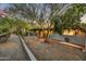 Charming backyard featuring a covered patio, desert landscaping, and mountain views at 6002 E Cholla Rd, Cave Creek, AZ 85331