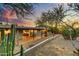 Spacious backyard featuring a covered patio and desert landscaping for relaxing and entertaining at 6002 E Cholla Rd, Cave Creek, AZ 85331