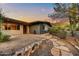 Charming single-story home featuring a stone pathway and low-maintenance desert landscaping at 6002 E Cholla Rd, Cave Creek, AZ 85331