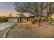 Inviting single-story home with a spacious front yard, mature tree, and desert landscaping at 6002 E Cholla Rd, Cave Creek, AZ 85331