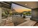 Charming front yard features desert landscaping, a stone walkway, and a tranquil sunset at 6002 E Cholla Rd, Cave Creek, AZ 85331