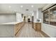 Spacious kitchen features modern white cabinets, natural wood accents and a quartz countertop breakfast bar at 6002 E Cholla Rd, Cave Creek, AZ 85331