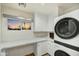 Laundry room featuring stackable washer and dryer and white countertops at 6002 E Cholla Rd, Cave Creek, AZ 85331