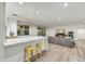 Bright living area features light wood floors, recessed lighting, breakfast bar, and large gray sectional couch at 6002 E Cholla Rd, Cave Creek, AZ 85331
