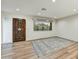 Entryway features light wood floors, area rug, and a decorative wood front door at 6002 E Cholla Rd, Cave Creek, AZ 85331