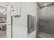 Well-lit bathroom featuring a tiled shower with glass doors, gray paint, and stylish fixtures at 6055 E Hannibal St, Mesa, AZ 85205