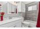 Updated bathroom boasts modern fixtures, vanity with white cabinets and tile backsplash in shower at 6055 E Hannibal St, Mesa, AZ 85205