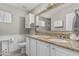 Bathroom features double sinks, granite countertops, a large mirror, and neutral paint at 6055 E Hannibal St, Mesa, AZ 85205