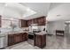 Well-lit kitchen boasting stainless steel appliances, skylight, ample counter space, and stylish dark cabinetry at 6055 E Hannibal St, Mesa, AZ 85205