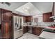 Modern kitchen features stainless steel appliances, spacious countertops, and rich dark wood cabinetry at 6055 E Hannibal St, Mesa, AZ 85205