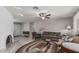 Comfortable living room with a fireplace, tile floors, ceiling fan, and neutral paint scheme creating a warm ambiance at 6055 E Hannibal St, Mesa, AZ 85205