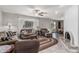 Inviting living room featuring tile floors, a ceiling fan, a fireplace, and comfortable seating arrangements at 6055 E Hannibal St, Mesa, AZ 85205