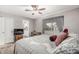 Serene main bedroom with neutral tones, ceiling fan, TV, and en-suite bathroom access at 6055 E Hannibal St, Mesa, AZ 85205