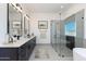 Modern bathroom with double vanity, undermount sinks, walk-in shower with glass, and freestanding tub at 6509 W Apex Ave, Queen Creek, AZ 85144
