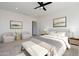 Serene bedroom with neutral colors, bench, art, ceiling fan and large windows at 6509 W Apex Ave, Queen Creek, AZ 85144