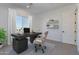 Bright office space with dark wood desk, modern chair and window providing natural light at 6509 W Apex Ave, Queen Creek, AZ 85144