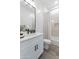 Bright bathroom featuring a white vanity with black hardware, a shower/tub combo, and decorative accents at 6564 W Apex Ave, Queen Creek, AZ 85144