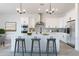 Modern kitchen boasts a large island with seating, stainless steel appliances, and sleek white cabinetry at 6564 W Apex Ave, Queen Creek, AZ 85144