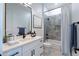 Modern bathroom features a quartz countertop vanity and a tiled shower and bathtub at 6579 W Apex Ave, Queen Creek, AZ 85144