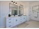Modern bathroom with double vanity, large mirrors, and tiled floors at 6579 W Apex Ave, Queen Creek, AZ 85144