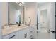 Bright bathroom features a white vanity with black hardware and a framed mirror at 6579 W Apex Ave, Queen Creek, AZ 85144