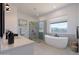 Modern bathroom featuring a freestanding tub, glass-enclosed shower, and bright natural light at 6579 W Apex Ave, Queen Creek, AZ 85144