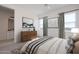 Relaxing bedroom with muted tones, cozy bedding, and natural light from two windows at 6579 W Apex Ave, Queen Creek, AZ 85144