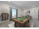 Game room with a billiards table, pool cue rack, and neutral-colored carpet at 6579 W Apex Ave, Queen Creek, AZ 85144