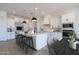 Bright modern kitchen featuring stainless steel appliances, white cabinetry, and a center island with seating at 6579 W Apex Ave, Queen Creek, AZ 85144