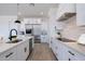 Modern kitchen featuring white cabinets, stainless steel appliances, and a white stone backsplash at 6579 W Apex Ave, Queen Creek, AZ 85144