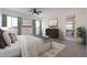 Main bedroom with neutral walls, carpet floor, ceiling fan, and an open bathroom area with tub at 6579 W Apex Ave, Queen Creek, AZ 85144
