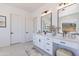 Elegant bathroom featuring a large vanity with dual sinks, modern lighting, and neutral tones at 6604 W Apex Ave, Queen Creek, AZ 85144