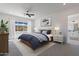 Tranquil bedroom with neutral tones, a ceiling fan, and a picturesque view from the window at 6604 W Apex Ave, Queen Creek, AZ 85144