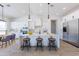 Bright, open kitchen with stainless steel appliances, a large island, and modern pendant lighting at 6604 W Apex Ave, Queen Creek, AZ 85144