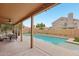 Relaxing covered patio area overlooking a spacious pool and manicured backyard at 6901 W Tonto Dr, Glendale, AZ 85308