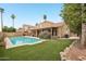 Lush backyard with a sparkling pool, inviting patio, and well-maintained lawn at 6901 W Tonto Dr, Glendale, AZ 85308