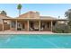Sparkling pool and backyard with covered patio seating, ideal for enjoying sunny days at 6901 W Tonto Dr, Glendale, AZ 85308