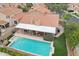 Aerial view of an in-ground pool, patio, and landscaped backyard, perfect for outdoor entertaining at 6901 W Tonto Dr, Glendale, AZ 85308