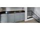 Basement area with gray cabinets and dark granite countertops at 6901 W Tonto Dr, Glendale, AZ 85308