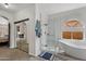 Bright bathroom features a walk-in shower, soaking tub, and large mirror closet at 6901 W Tonto Dr, Glendale, AZ 85308