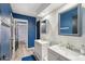 Modern bathroom featuring dual sinks, blue accent wall, and stylish fixtures at 6901 W Tonto Dr, Glendale, AZ 85308