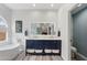 A bright bathroom features double vanities, a soaking tub, and a separate water closet with blue walls at 6901 W Tonto Dr, Glendale, AZ 85308