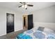 Bedroom featuring white walls, ceiling fan, and blue and white bedding at 6901 W Tonto Dr, Glendale, AZ 85308