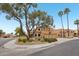Street view of a two-story home with a terracotta roof and a large tree in the front yard at 6901 W Tonto Dr, Glendale, AZ 85308