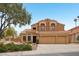 Two-story home featuring a three-car garage, a well-maintained yard, and a terracotta roof in a suburban neighborhood at 6901 W Tonto Dr, Glendale, AZ 85308
