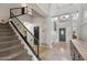 Spacious foyer with staircase, decorative lighting, and tile flooring at 6901 W Tonto Dr, Glendale, AZ 85308